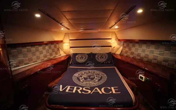 Cozy bedroom with Versace bedding inside Al Shali yacht