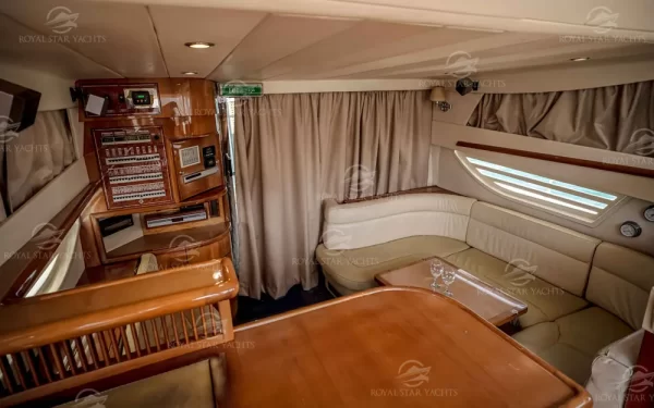 Wood finish cabin area with dining space inside Enterprise yacht Dubai